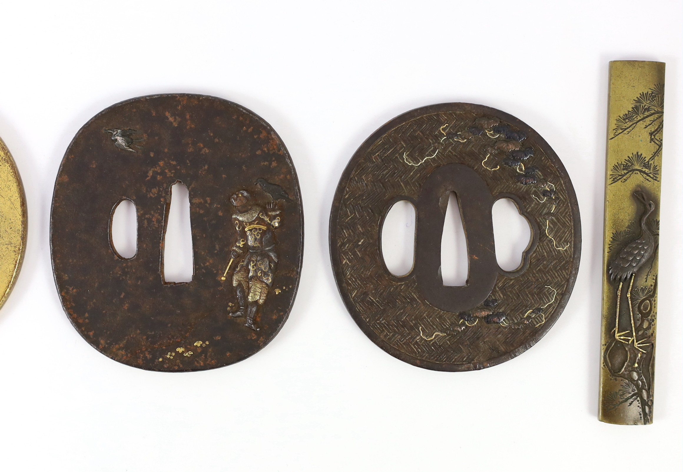 A group of Japanese bronze, iron and mixed metal tsuba and a kozuka knife handle, 19th century